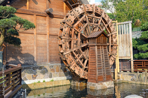 Vintage wooden waterwheel at water mill used to generate power photo