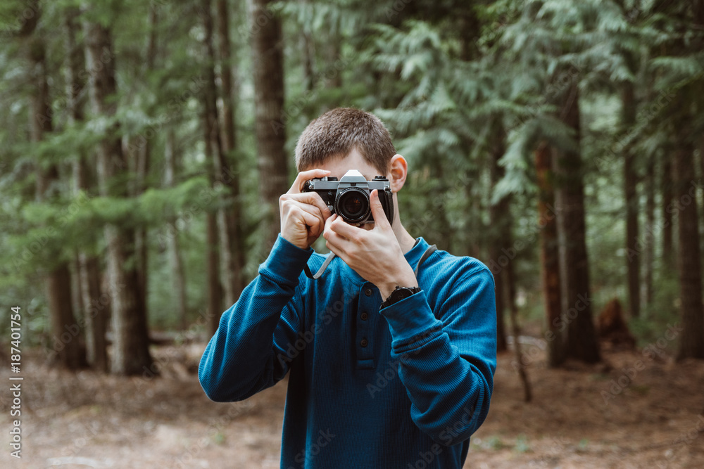 Man taking a photo with an antique 35mm film camera. Man taking a photo with an antique 35mm film camera.