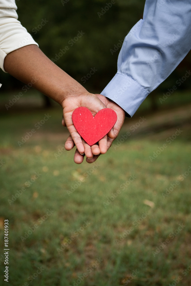 Happy loving couple holding a heart. Happy loving couple holding a heart.