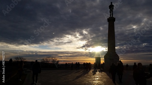 Silhouette od Pobednik (Winner ) monument erected on Kalemegdan Fortress in Belgrade at sunset photo