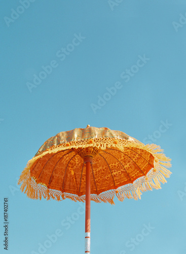 decorative orange parasol against a blue sky photo