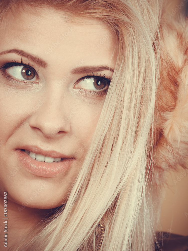 Blonde woman in winter earmuffs and jacket. Blonde woman in winter earmuffs and jacket.