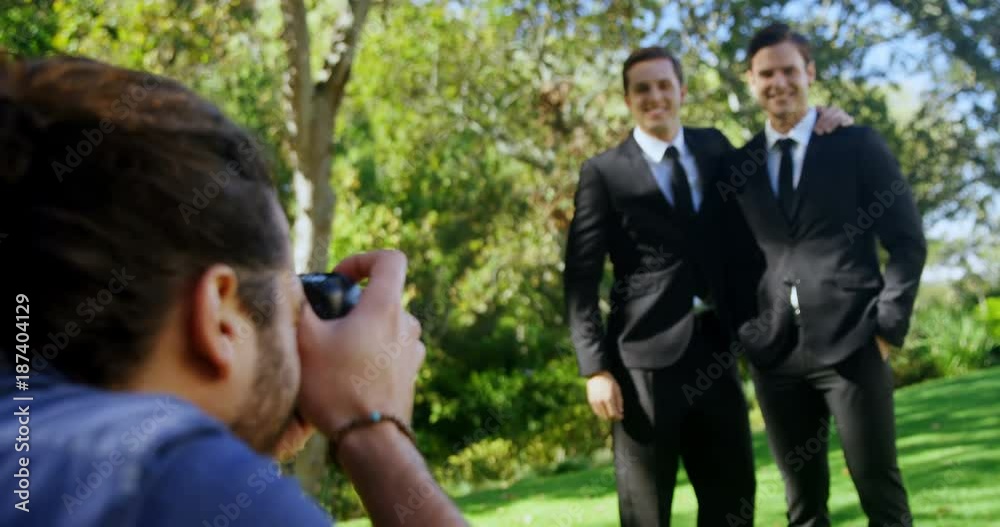 Photographer taking photo of groomsmen  