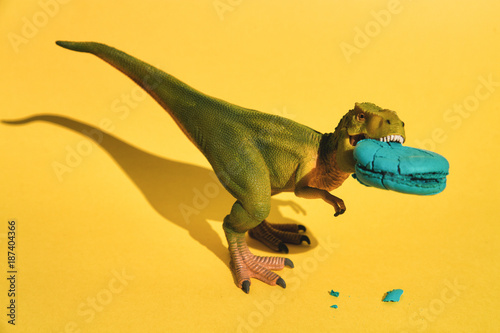 Plastic T-Rex with macaroon in mouth photo