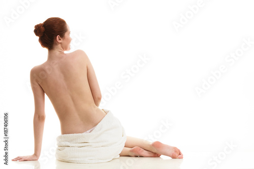 Sitting naked woman in white towel