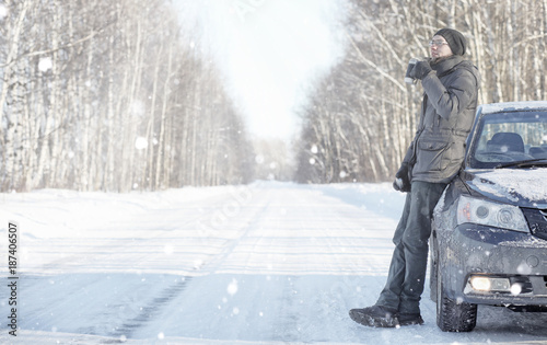 Man drink tea from mug outdoor on winter road