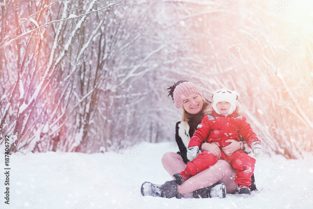 Young family with children are walking in the winter park. Winte Young family with children are walking in the winter park. Winte