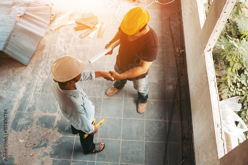 Top view engineer shaking hands with employers for renovation old house