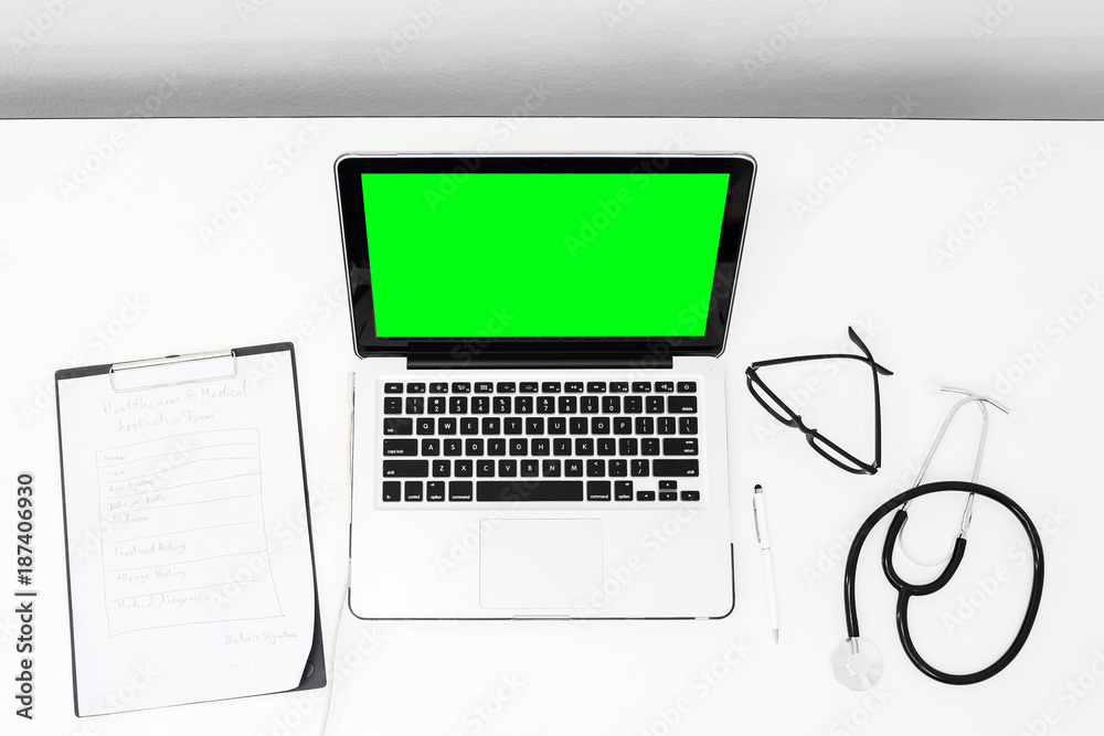 Top view doctor working hard at desk with green screen laptop equipment. Top view doctor working hard at desk with green screen laptop equipment.