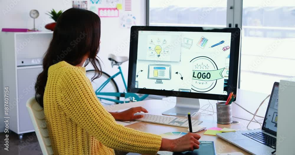 Creative executive using graphic tablet while working on desktop pc Creative executive using graphic tablet while working on desktop pc