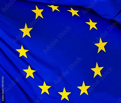 The flag of the European Union , against the background of the sunny sky.