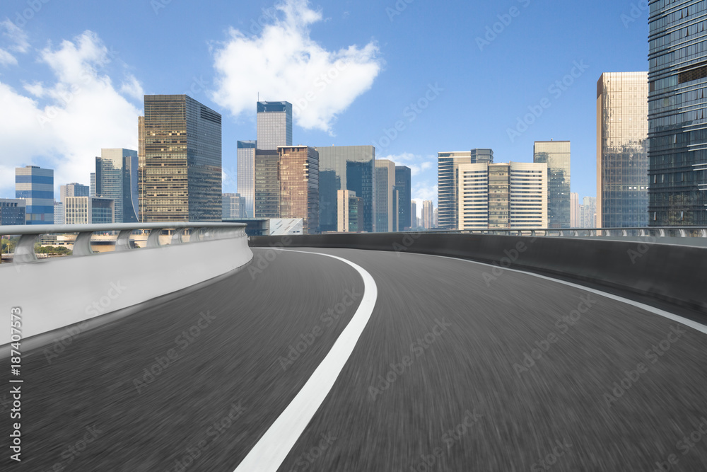 city empty traffic road with cityscape in background city empty traffic road with cityscape in background