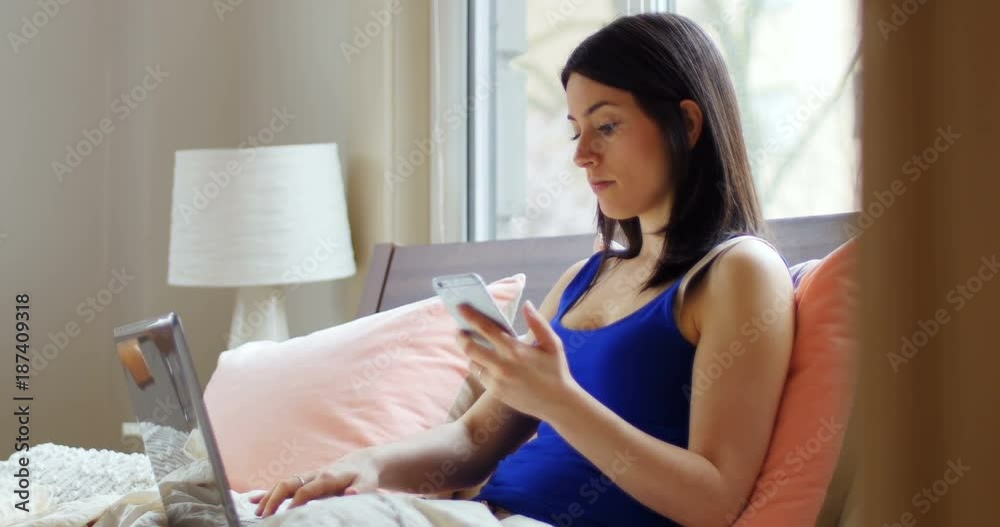 Young woman using laptop and mobile phone Young woman using laptop and mobile phone
