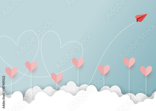 Paper art style of valentine's day greeting card and love concept.Red paper airplane flying look like couple of heart shape on clouds and blue sky.Vector illustration.