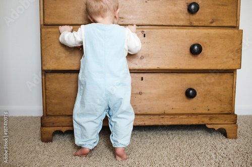 baby looking in a drawer photo