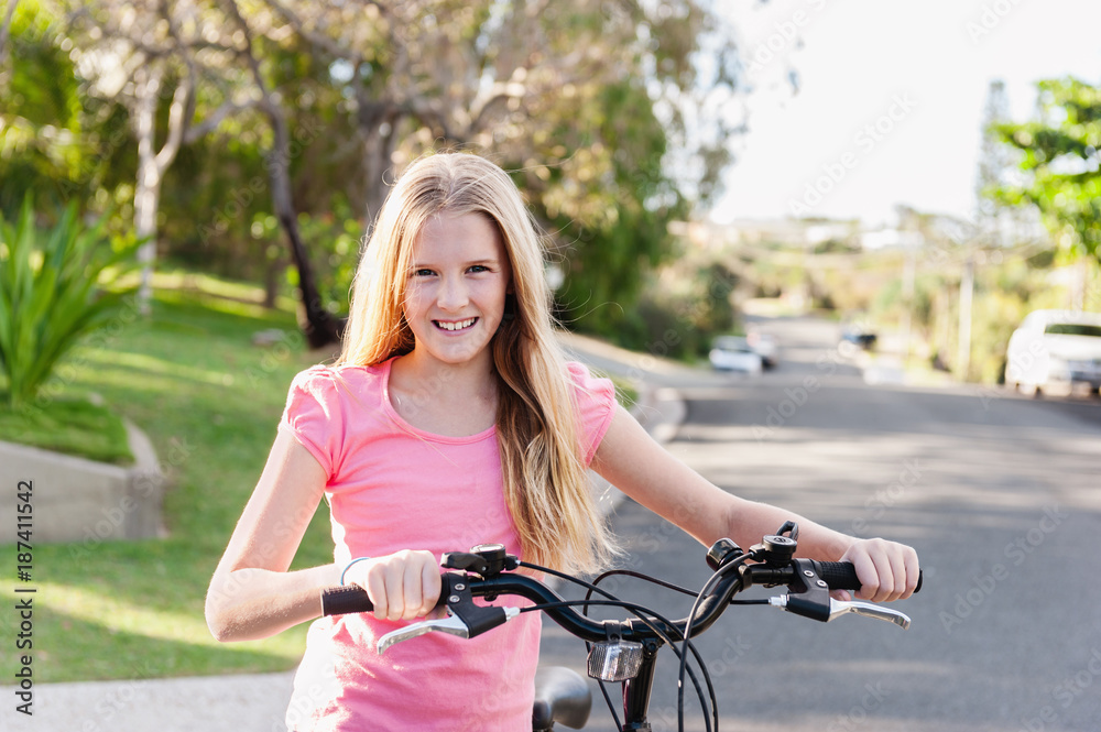 tween girl riding her bike on the road Stock Photo Adobe Stock