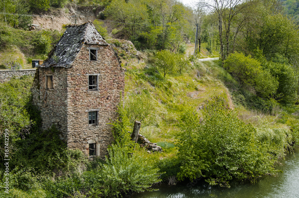 Old ruined house on the banks of the river Aveyron Belcastel France