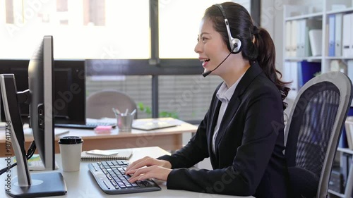 Call center business woman talking on headset.