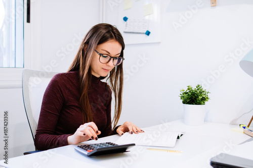 Young businesswoman working in office photo