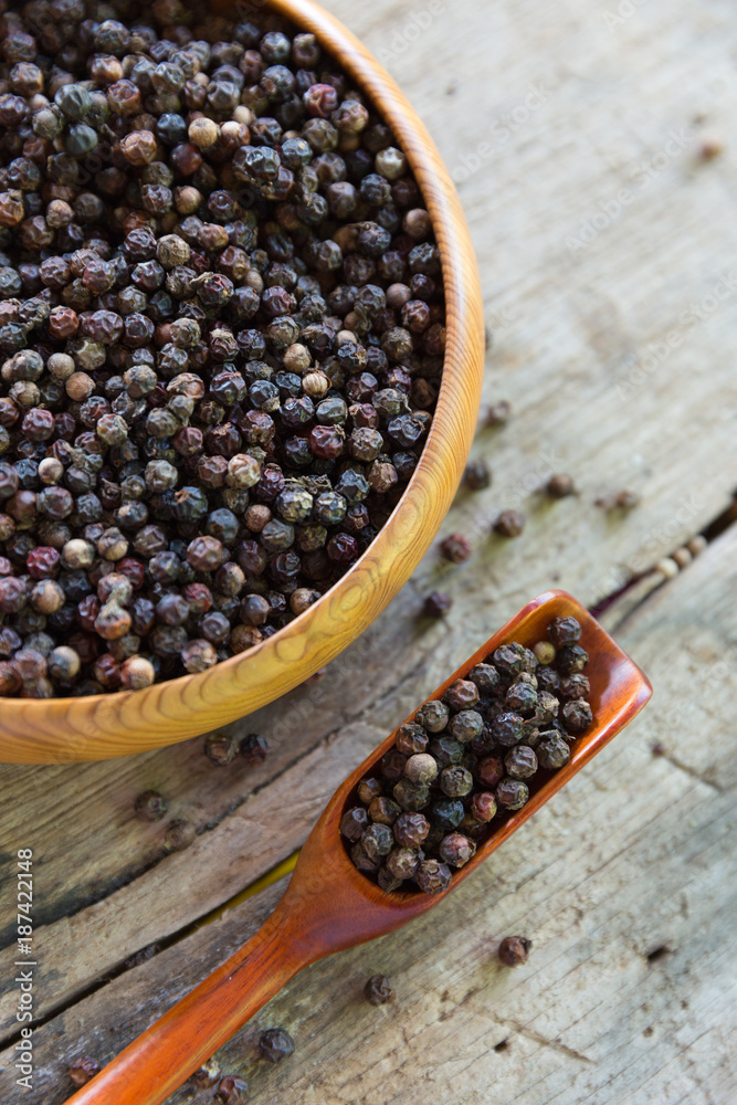 Close up black pepper seed in wooden spoon Close up black pepper seed in wooden spoon