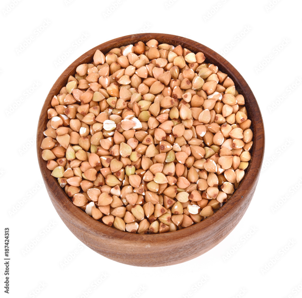 buckwheat in a wooden bowl isolated on white background