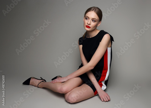 high fashion woman in short black dress.