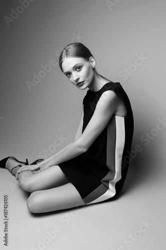 high fashion woman in short black dress.