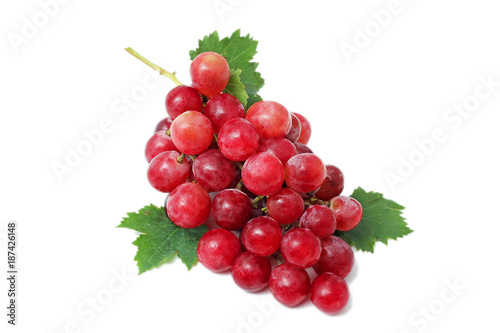 Ripe red grape. Pink bunch with leaves isolated on white. 