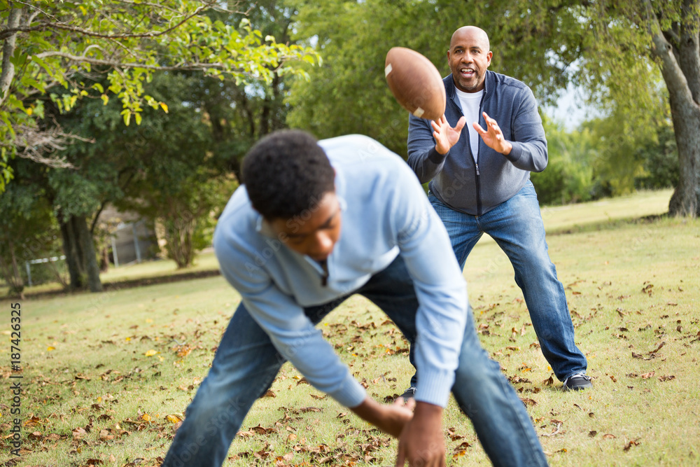 Father and son playing football. Father and son playing football.