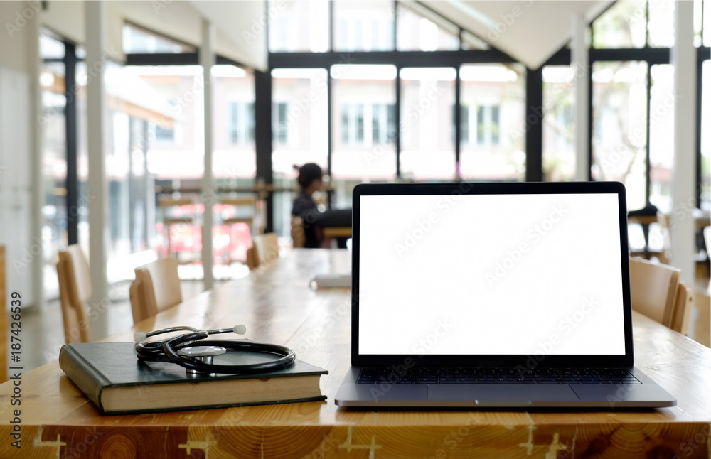 Mock up laptop on a table in classroom. Mock up laptop on a table in classroom.