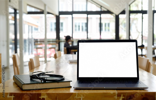 Mock up laptop on a table in classroom. © bongkarn