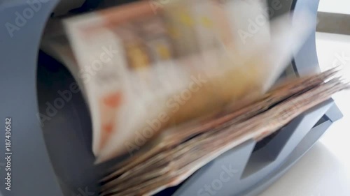 Cash money counting machine. Banknote counter are counting fifty euro bills.