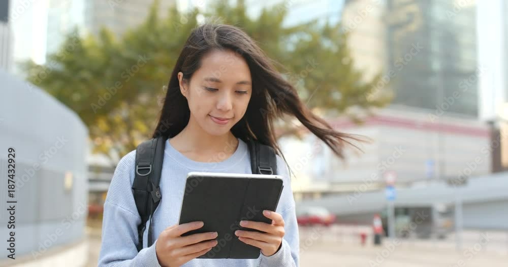 Asian woman using tablet computer at outdoor Asian woman using tablet computer at outdoor