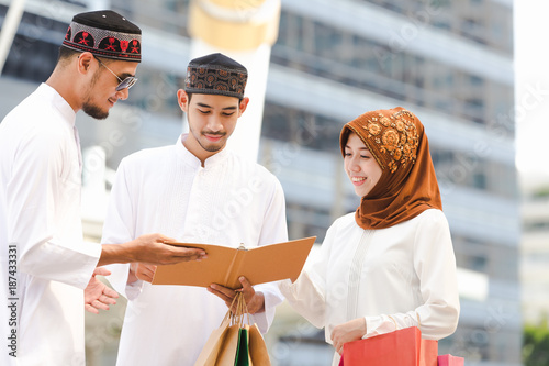 Muslim teen group reading book with shopping in the city,Concept education and shopping