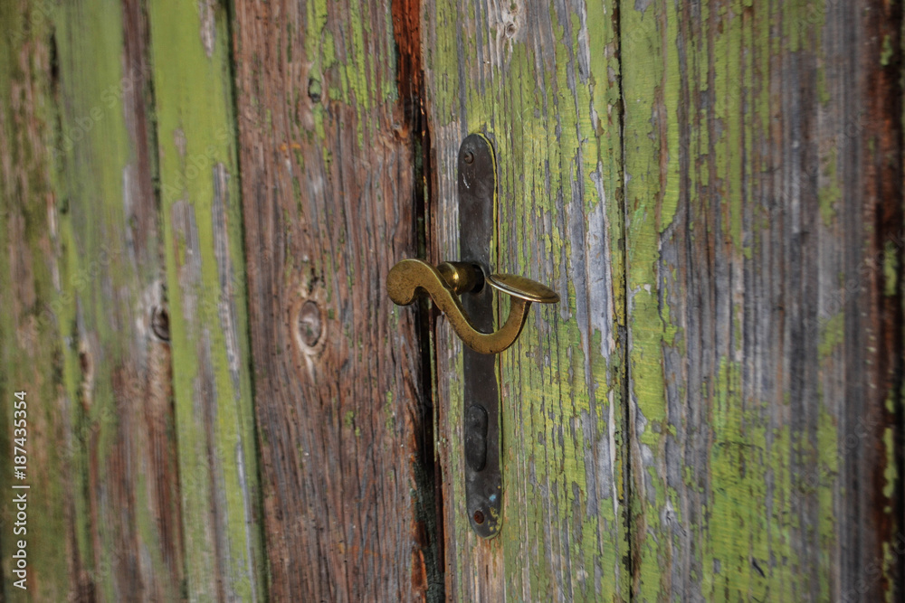 Old door knob at the old wooden door