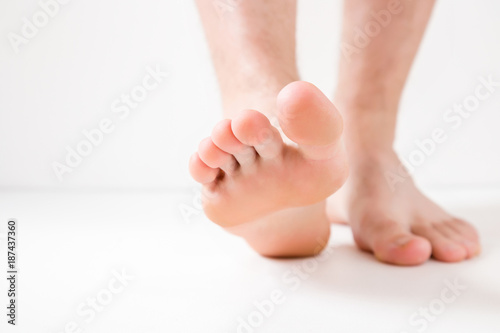 Barefoot. Cares about a man's clean and soft foot skin. Body care concept.