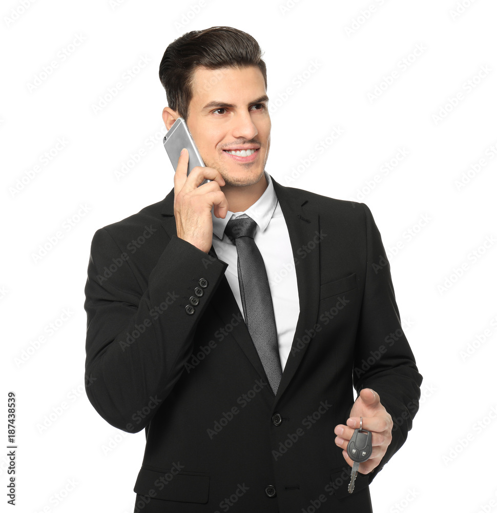Car salesman in formal suit talking on phone against white background Car salesman in formal suit talking on phone against white background