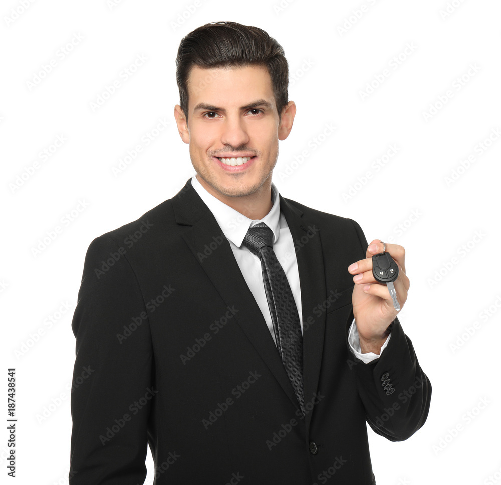 Salesman in formal suit holding car key on white background Salesman in formal suit holding car key on white background