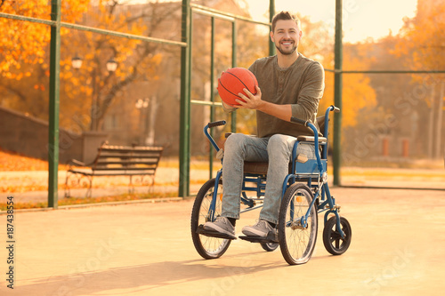 Young man in wheelchair wit...