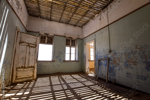 Inside view of one of the abandoned houses in the ghost town of Kolmanskop near L  deritz in Namibia  Africa. After the diamond rush ended  the houses are slowly getting swallowed by sand and dunes.