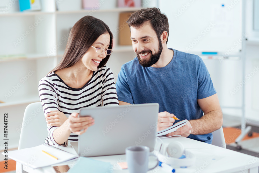 Business ambitions. Cheerful appealing two colleagues hopping to establish business and discussing opportunities Business ambitions. Cheerful appealing two colleagues hopping to establish business and discussing opportunities