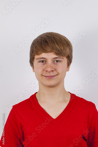 smiling teenage boy with red shirt isolated on white