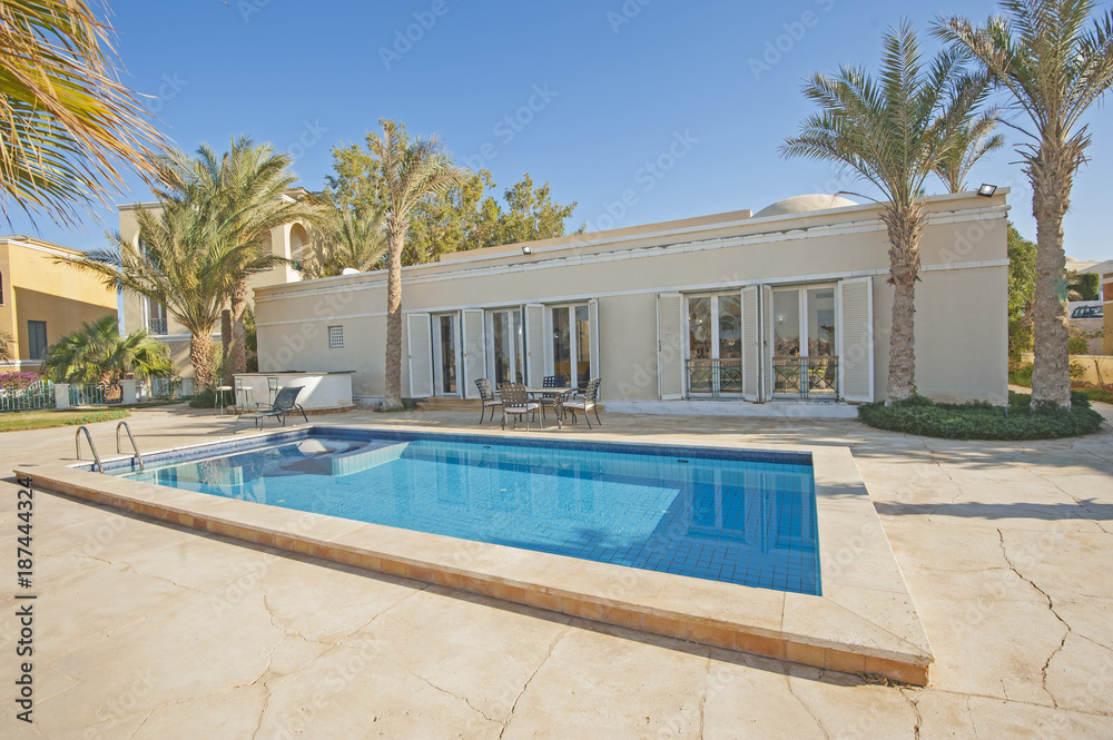Fototapeta premium Swimming pool at at luxury tropical holiday villa