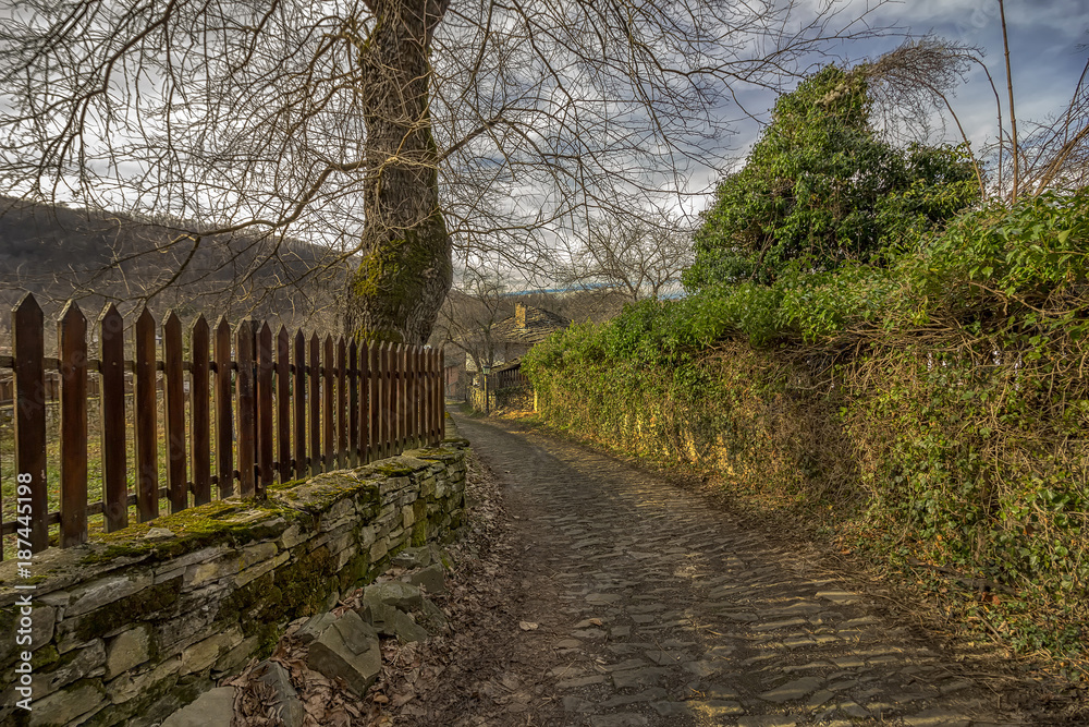 Beauty view at old stone street and fence in ancient village Beauty view at old stone street and fence in ancient village