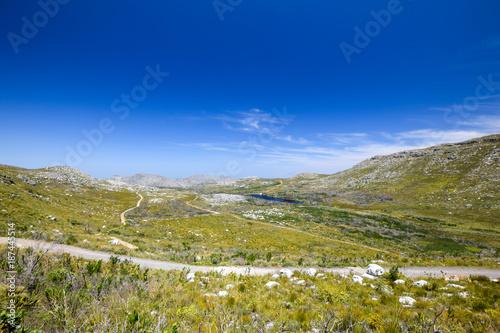 Beautiful view of a hiking trail in Silvermine Nature Reserve, part of the Table Mountain National Park in Cape Town, South Africa. The Silvermine reservoir in the background. photo