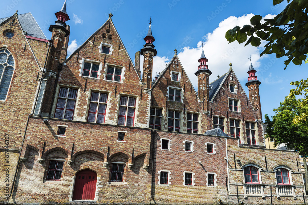 Naklejka premium Old houses along of a canal in Bruges, Belgium