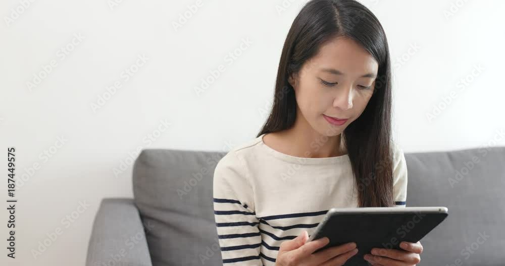 Woman use of digital tablet computer at home