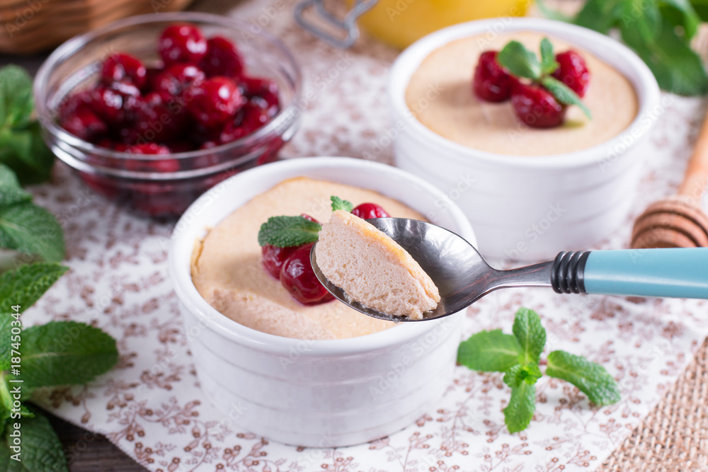 Dessert with cherry in a glass jars on wooden background Dessert with cherry in a glass jars on wooden background