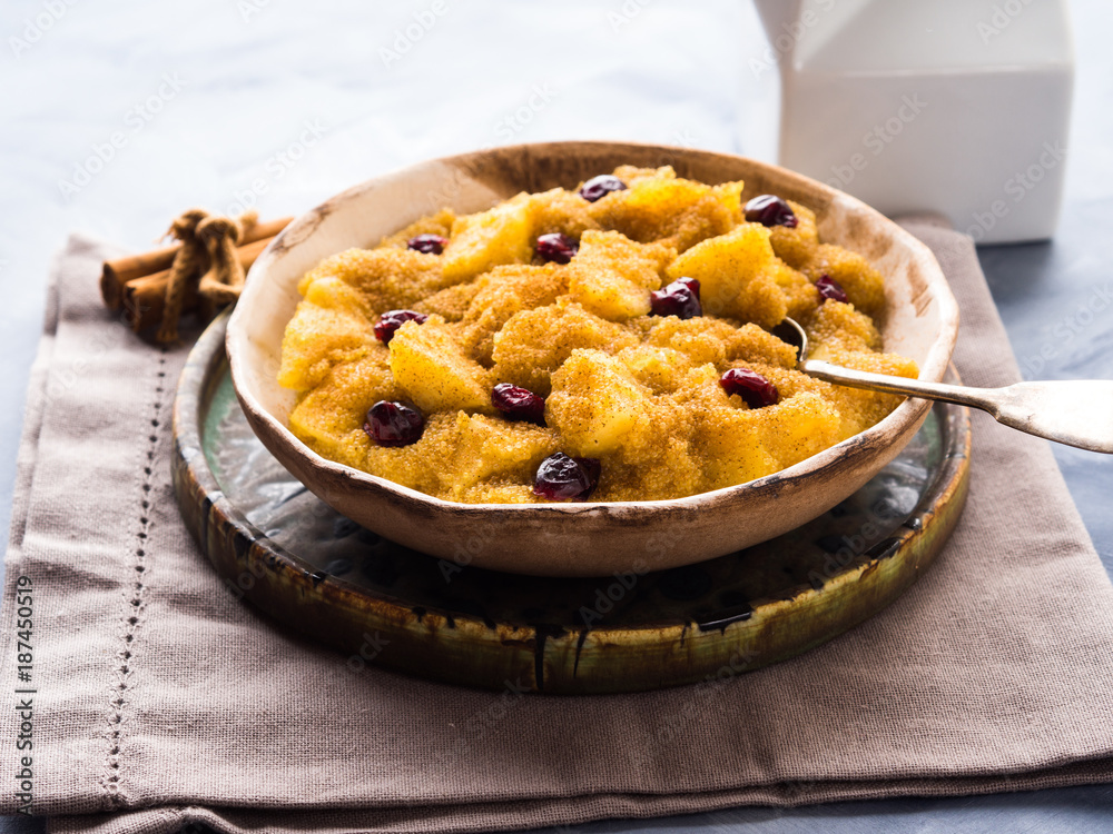 Amaranth porridge with apples, cinnamon, turmeric and dried fruit. Gluten free breakfast meal