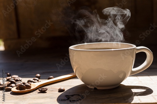 Coffee cup and coffee beans on table